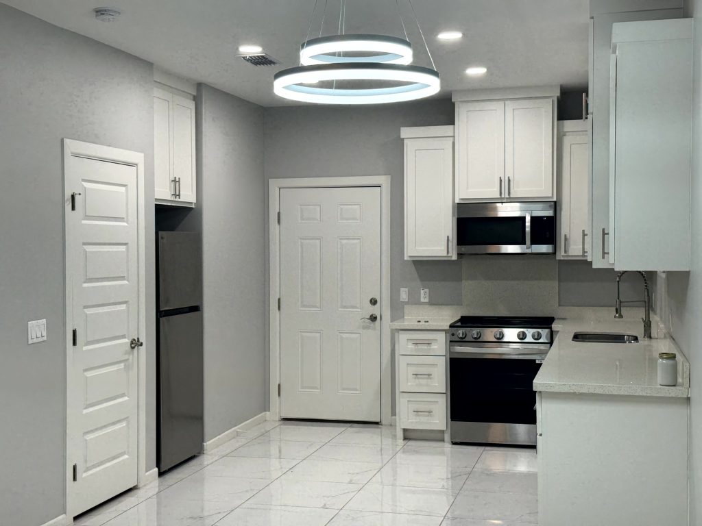Kitchen with refrigerator, range and microwave
