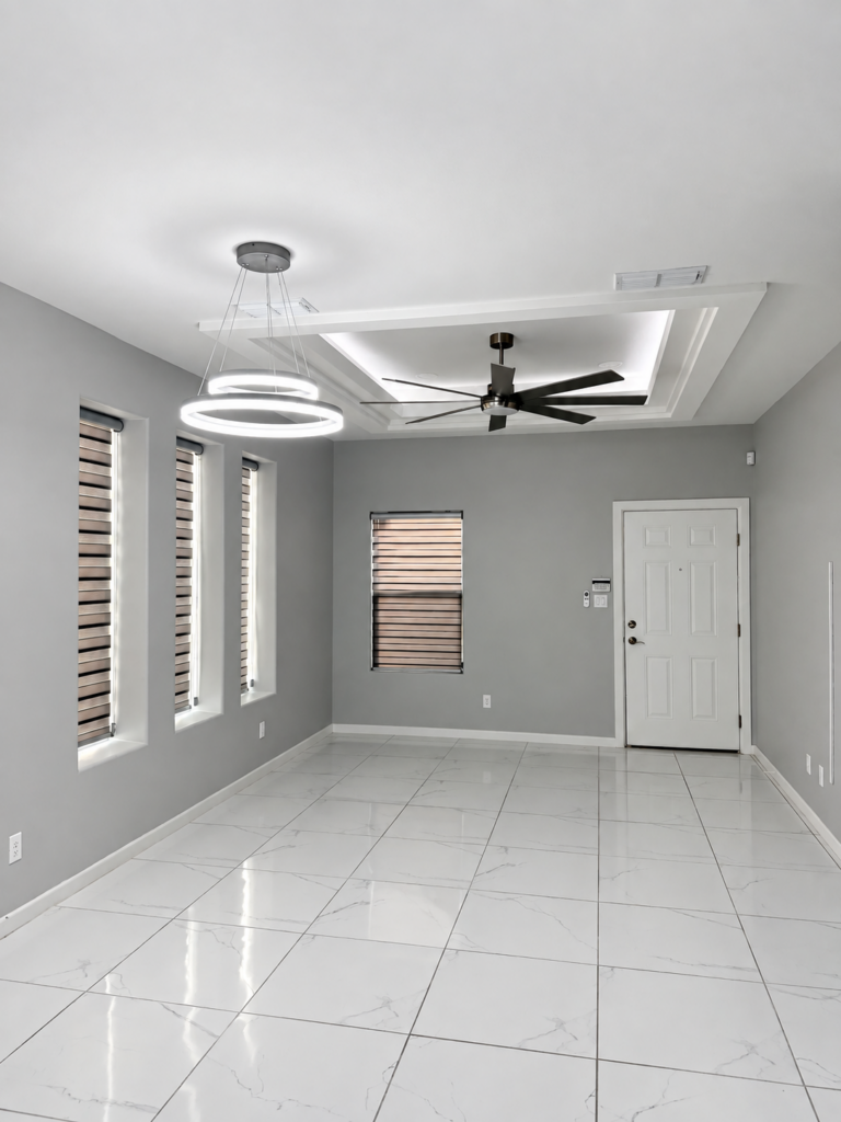 Living area with decorative ceiling and front entrance